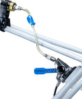 Heavy Duty Hydraulic Bicycle Brake Bleed Kit With DOT Fluid Dual Syringes Quick Connect Hoses Bleed Blocks And Mounts For SRAM Formula Hayes Hope And More in use on a bike frame