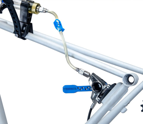 Heavy Duty Hydraulic Bicycle Brake Bleed Kit With DOT Fluid Dual Syringes Quick Connect Hoses Bleed Blocks And Mounts For SRAM Formula Hayes Hope And More in use on a bike frame