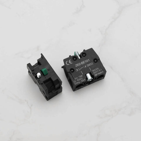 Slick Heavy Duty Green Push Button Switch Rugged 600 Volt 10 Amp Normally Open Contact Block with silver terminals, side view.