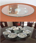 Clear Glass Turntable Bearing With Heavy Duty Aluminum Alloy Support on table, serving plates arranged, smooth rotating surface.