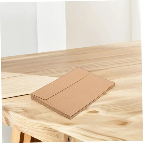 60 Pack Kraft Paper Self-Seal Envelopes, Letter Size 10.8 X 15.9 Cm, on wooden table, rustic look for wedding invitations.