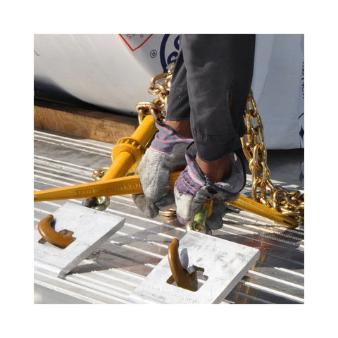 Person using Heavy Duty Ratchet Load Binder For 3/8 To 1/2 Inch Grade 70 Transport Chain, yellow finish, on flatbed trailer.