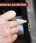 Hand applying Scratch Fix Marker Pen For Wood Floors And Furniture, Quick Dry Filler Pen That Actually Stays Put on a wood scratch