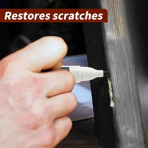 Hand applying Scratch Fix Marker Pen For Wood Floors And Furniture, Quick Dry Filler Pen That Actually Stays Put on a wood scratch