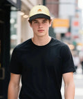 Man wearing Proud Mom Of 2026 Grad Hat For Women And Men Dope Unisex Adjustable Trucker Cap with breathable mesh on city street