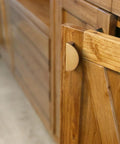 Champagne Bronze Zinc Alloy Cabinet Drawer Pull installed on a wooden cabinet door, offering a striped decorative design with solid construction.