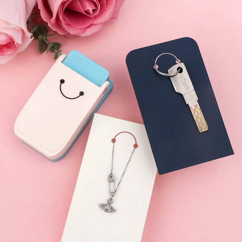 3 In 1 Hangtag Punch Kit with Portable Hole Punch, keychains, jewelry displays, and cardstock on a pink background