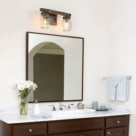 Two Light Mason Jar Vanity Light With Faux Wood Finish in bathroom setting over mirror