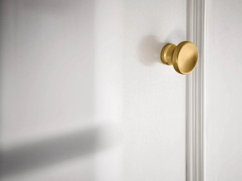 Colinet Brushed Gold 1 Inch Diameter Cabinet And Drawer Knob In Traditional Decorative Style on white cabinet door