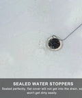 2 Pcs Black Silicone Bathtub Drain Stopper with Chain for Shower Use, shown in water, demonstrating flat cover sealing drain.