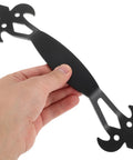 Person holding black iron cabinet door handle, vintage metal pull visible, for dresser drawers and wardrobes, farmhouse chic.