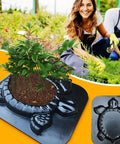 Turtle Stepping Stone Mold for Concrete Pathways 17.3 by 15 by 1.6 Inch cement mold with a plant growing, shown in a garden setting.