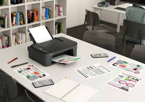 Slick Wireless All In One Home Office Printer Scanner Copier on desk with documents, mobile devices, and notebook.