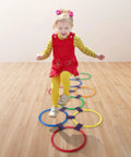 Child playing with Hopscotch Rings Game Kit With Ten 11 Inch Plastic Rings And Fifteen Connectors for indoor fun