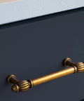 Antique brass cabinet pull on dark cabinet; focus on Six Pack Antique Brass Cabinet Pulls in Zinc Alloy for Kitchen and Furniture.