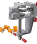 Rock Steady Mini Bench Vise Snags Loose Pieces For Jewelry Woodcarving And Watch Repair Ace Portable Table Vice with orange grips.