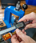 Electronic Caliper With LCD Display For Reloading, Precision To 0.001 Inch, measuring brass case near blue press