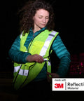 Heavy Duty Breakaway Mesh Hi Vis Safety Vest With 3M Reflective Strips in use at night, showing reflective features and cargo pockets.