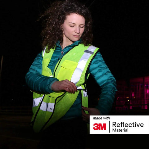 Heavy Duty Breakaway Mesh Hi Vis Safety Vest With 3M Reflective Strips in use at night, showing reflective features and cargo pockets.