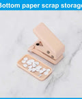 Pink handheld hole punch with paper scrap storage, ideal for crafts and scrapbooking.