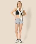 Women's Regular Fit Athletic Woven Running Shorts With Ruched Waistband, Zip Pocket, Breathable Lightweight Fabric, Four Way Stretch, Moisture Wicking, All Day Comfort, Gray Heather, Size Medium worn by woman posing
