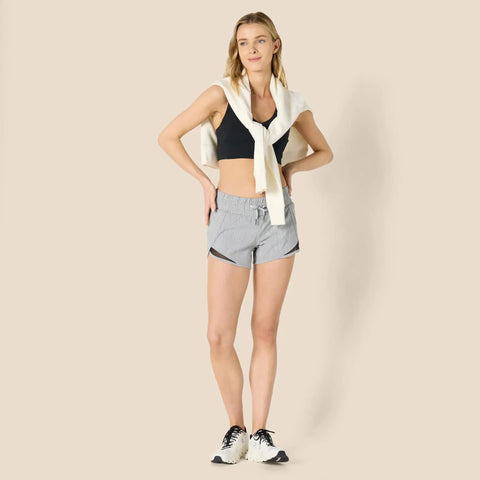 Women's Regular Fit Athletic Woven Running Shorts With Ruched Waistband, Zip Pocket, Breathable Lightweight Fabric, Four Way Stretch, Moisture Wicking, All Day Comfort, Gray Heather, Size Medium worn by woman posing