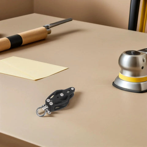 Heavy Duty Nylon Single Groove Pulley Block for Sailing on a workbench with tools in the background