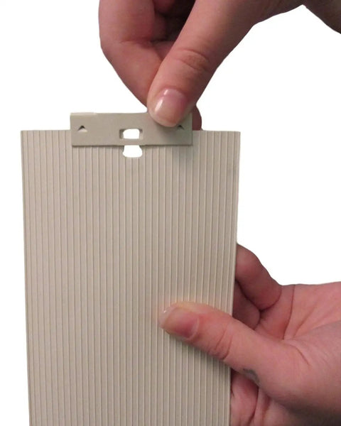 Hands holding vertical blind repair clips with curved vane saver for window blinds no fuss tabs fix replacement slats white 15 pack