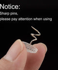 Kickass Upholstery Twist Pins Clear Heads 100 Piece Set showing sharp twist pin held between fingers for easy use.