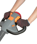 Hands gripping the controls of a Heavy Duty Electric Straddle Stacker 3300 Lb Capacity with ergonomic design.