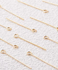 18K Real Gold Plated Eye Pins 21 Gauge 30mm Long, 100 Pack For DIY Jewelry Making, Beading Findings, Durable Craft Supply, Smooth Shine, Tarnish Resistant, Perfect For Earrings And Pendants, gold eye pins on textured white fabric