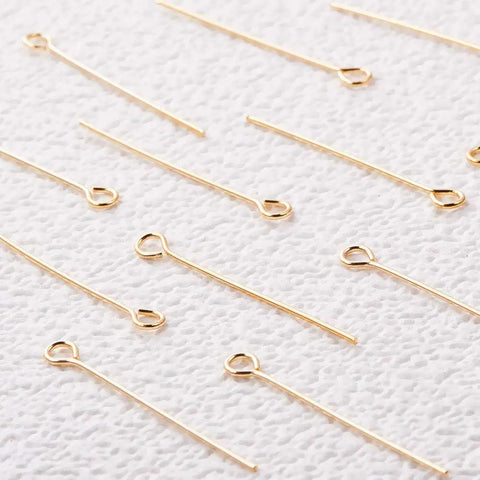 18K Real Gold Plated Eye Pins 21 Gauge 30mm Long, 100 Pack For DIY Jewelry Making, Beading Findings, Durable Craft Supply, Smooth Shine, Tarnish Resistant, Perfect For Earrings And Pendants, gold eye pins on textured white fabric