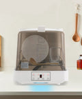 Game Changing Portable Countertop Dishwasher With Automatic Wash Cycle And Space Saving Build, showing dishes inside and control panel.