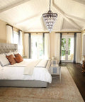Crystal Chandelier in Farmhouse Bronze, 4 Light Hanging Pendant Fixture illuminating an elegant bedroom with vaulted ceiling
