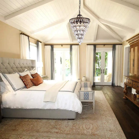 Crystal Chandelier in Farmhouse Bronze, 4 Light Hanging Pendant Fixture illuminating an elegant bedroom with vaulted ceiling