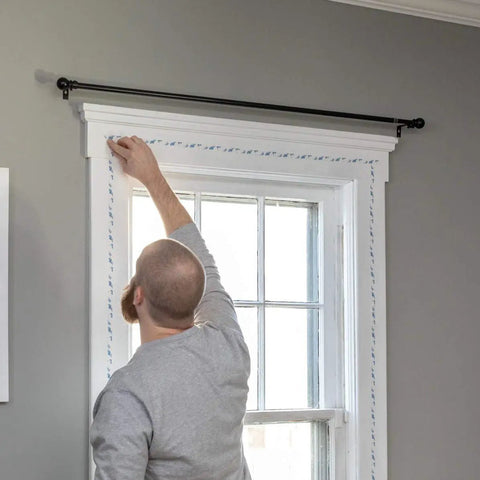 Installing Indoor Three Window Shrink Film Insulator Kit With Crystal Clear Film 62 By 126 Inches on window to stop drafts