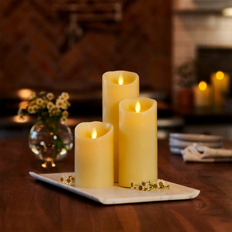 Cozy Flameless LED Candle With Moving Flame Pillar, Remote Ready And Timer, Battery Operated, Ivory Pillar on table