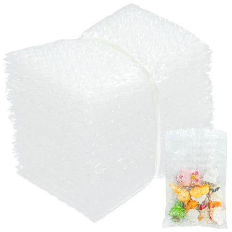 Pack Of 50 Clear 4x6 Bubble Pouches For Packing And Shipping Double Wall Cushioning Bags shown stacked with candy inside one pouch.