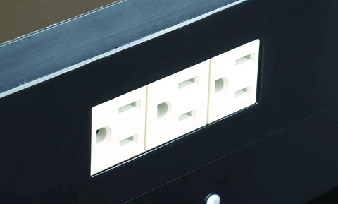 Three-outlet grounded power strip on heavy duty multipurpose workbench with built in outlets and light for DIY garage projects.