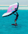 Surfer using the 5 Square Meter Surge Wind Wing For Foil Surfing And Wing Foiling With Two Window Design over turquoise water.
