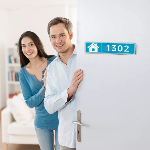 Couple smiling beside a door with Clear Acrylic Door Name Plates 2x8 Inches 5 Pack With Adhesive Tape