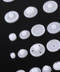 Durable Plastic Gear Kit Set For DIY Robots Cars And Tech Projects Includes 64 Wearable Crown Pulley Belt Gears Built Tough For Long Service Life Perfect For Creative Model Building And Mechanic Hobbyist Gadgets; white plastic gears on black
