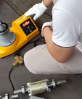 User adjusting the Straight Up Heavy Duty Digital Induction Coil Heater For Rapid Bearing Gear Bushing Shaft Sleeve Heating Operations.