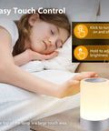 Child sleeping with Nursery Night Light For Baby With Dimmable Brightness And Easy Touch Control beside her bed.