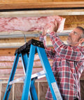 Premium Pink Fiberglass Insulation Batts For Interior Walls And Attic Cavities Heavy Duty unfaced man installing insulation on a ladder