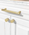 10 Pack 5 Inch Brushed Brass Knurled Cabinet Handles for Kitchen Cabinets Gold Pulls and Door Hardware installed on white cabinet