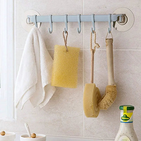 Self Adhesive Bathroom Towel Ring Holder With Rock Solid Grip Pad For Hassle Free Wall Mount Kitchen Storage Rack Stainless Steel Look hanging towels and sponges in a bathroom.