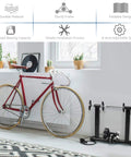 Indoor Bike Trainer Stand With Eight Level Magnetic Resistance for 26 to 28 Inch Wheels next to a red bicycle in home gym