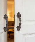 Vintage Cast Iron Door Handle Set 2 Pack Built Tough For Farmhouse Style Cabinet Pulls And Sliding Doors Fence Gates Cupboards Durable Antique Brown Finish on white doors