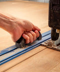 Low Profile Straight Edge Guide Rail Kit Extension Setup For Circular Saw Router And Jigsaw That Snaps Right On And Keeps Your Cuts Dead On Across Plywood And Solid Stock Wood, showing hand holding rail on wood.